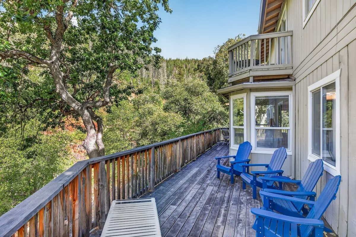 Deck with Adirondack chairs overlooking the forest