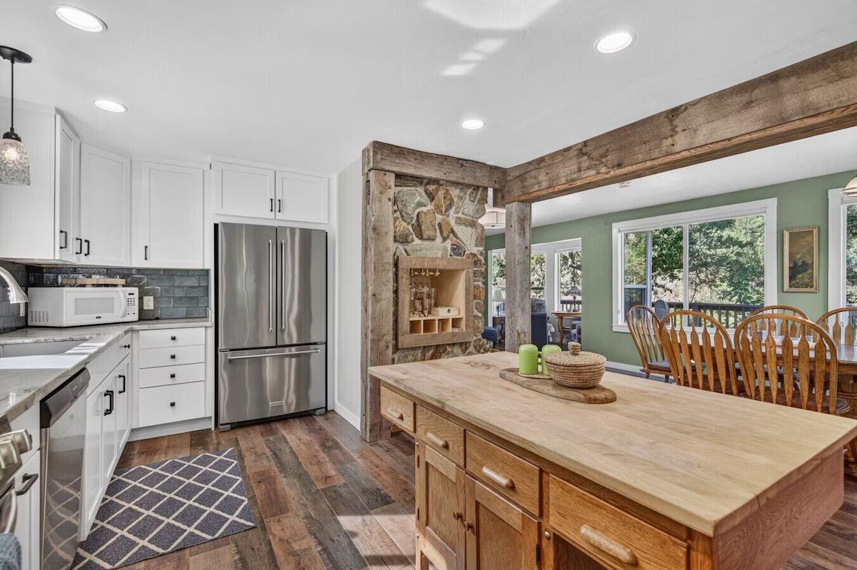 Farmhouse kitchen with wood beams and teal backsplash